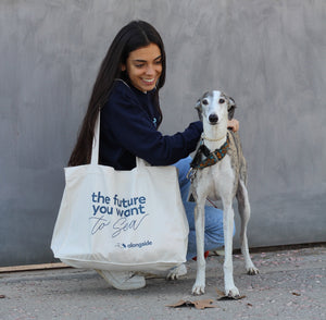 Sustainable bag alongside girl with greyhound